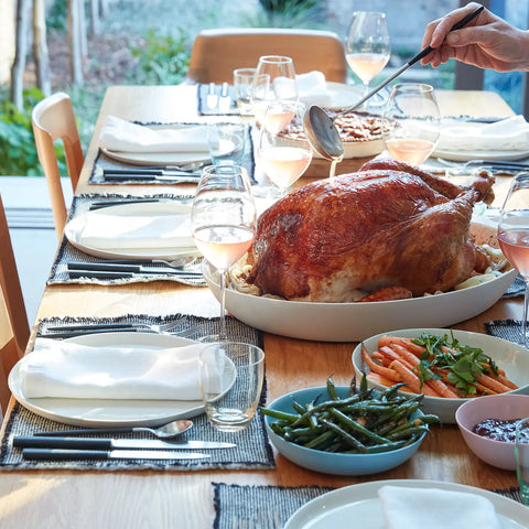 A beautifully set table with turkey in the middle