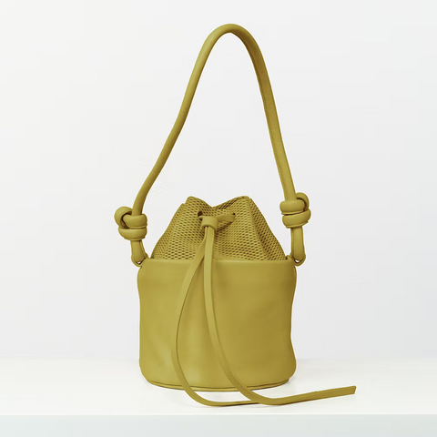 Woman holding small leather bag