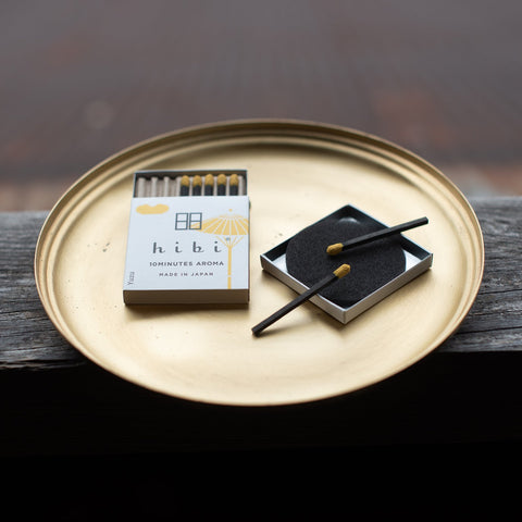 incense matches on a golden tray