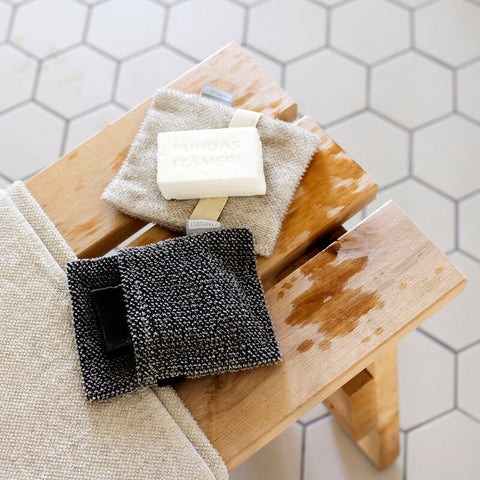 Soap and wash cloths sitting on bench