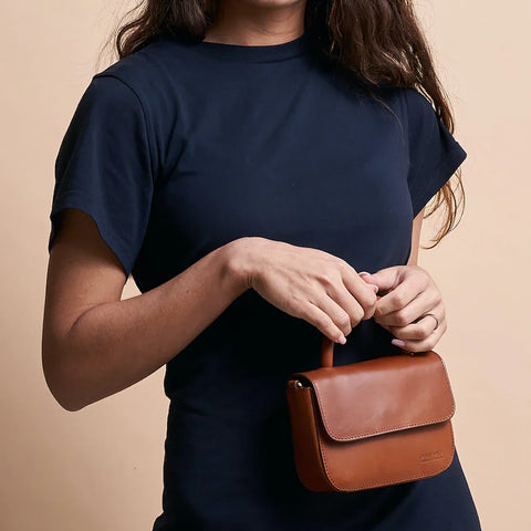 Woman holding small leather bag