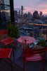 Red folding table with three red chairs.