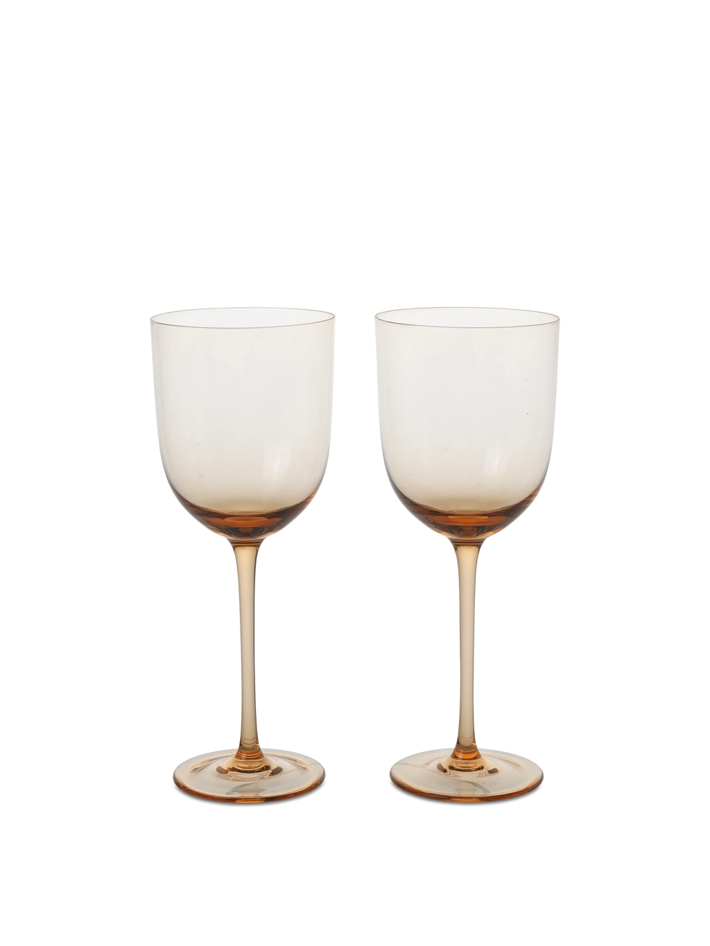A selection of elegant, mouth-blown glassware including wine glasses, cocktail glasses, and liqueur glasses, displayed on a table. The glassware comes in clear and various colored tints.