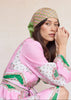 Woman wearing a pink and green traditional outfit with a patterned headscarf against a plain background