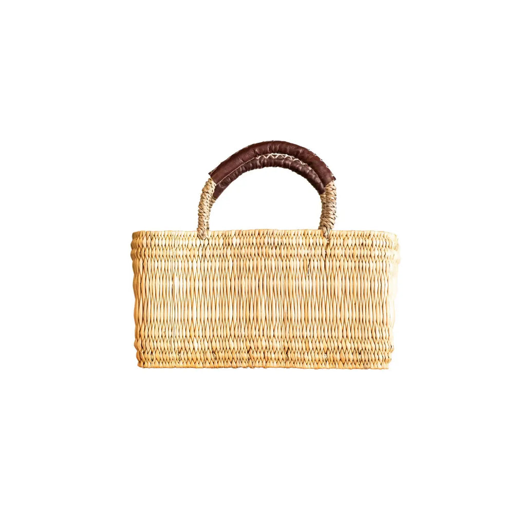 Woven basket with a brown handle on a white background