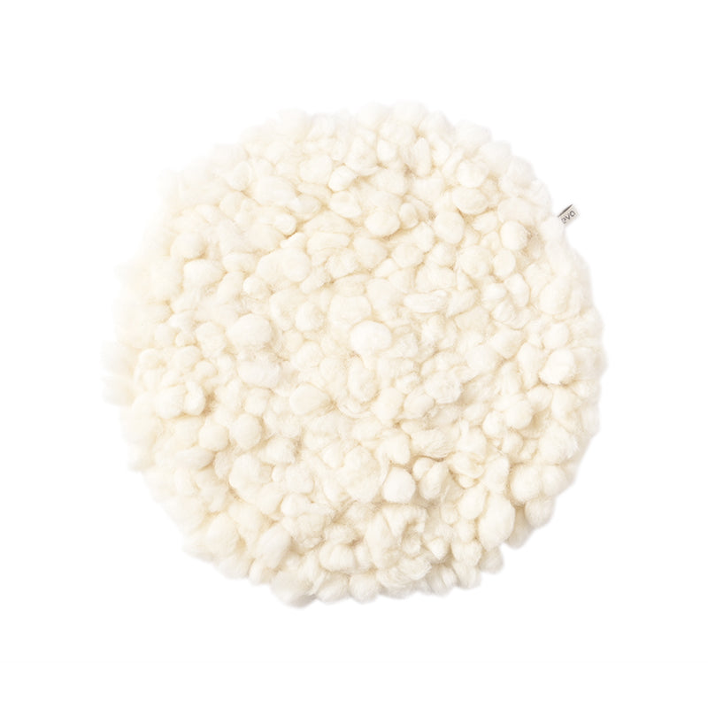 A cream round wool seat cushion with a white background.