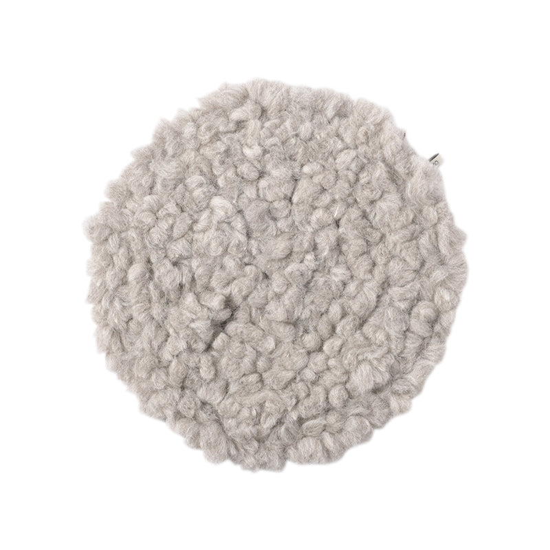 A grey round wool seat cushion with a white background.
