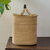Woven basket with handles on a wooden surface
