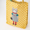 Yellow polka dot tote bag with a cat design on a white background