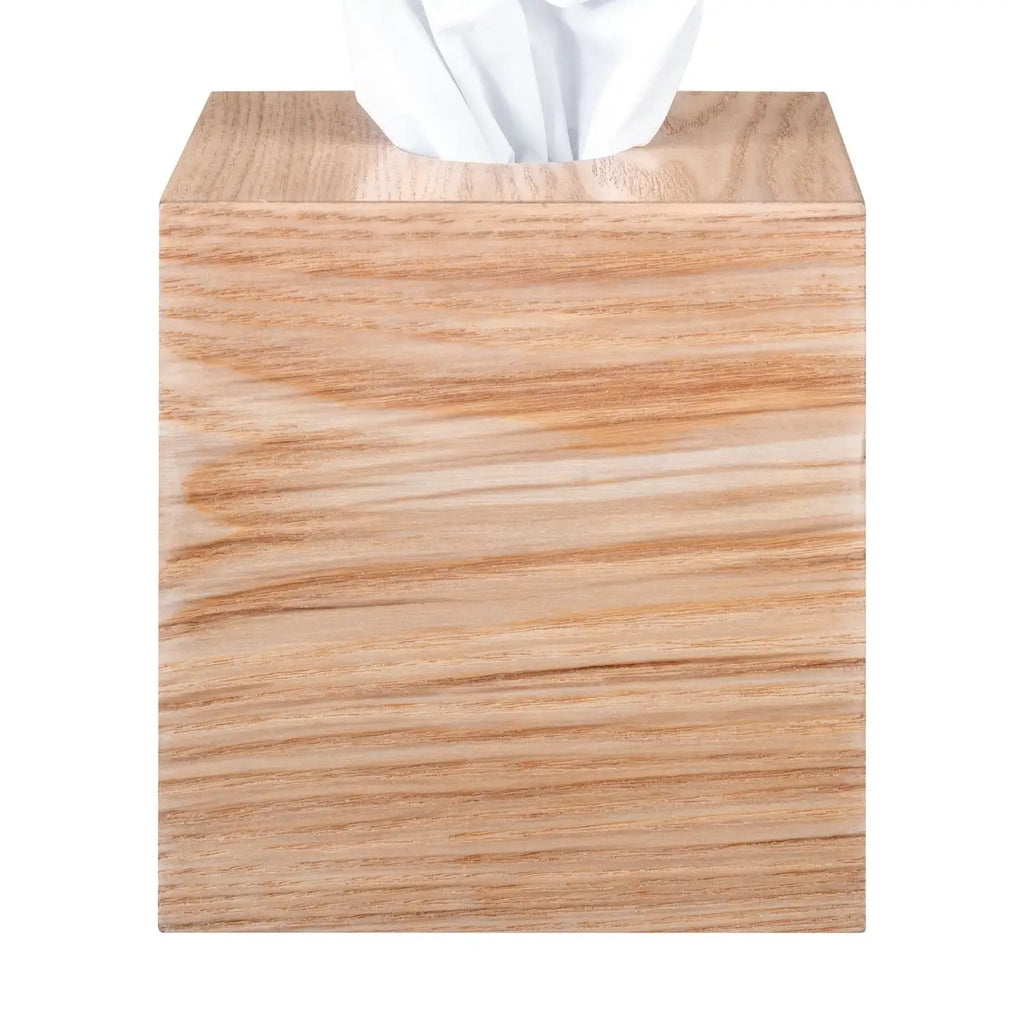 Wooden tissue box cover with tissues peeking out on a white background