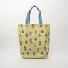 A yellow tote bag with a repeating pattern of French Bulldog characters wearing colorful sweaters, featuring light blue handles, set against a plain white background.