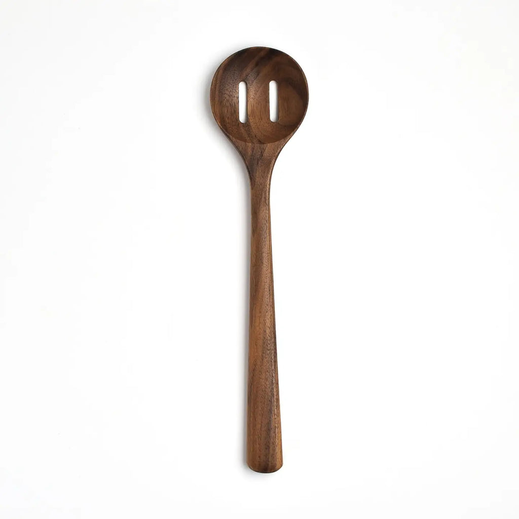 Wooden spoon with a slotted design on a white background