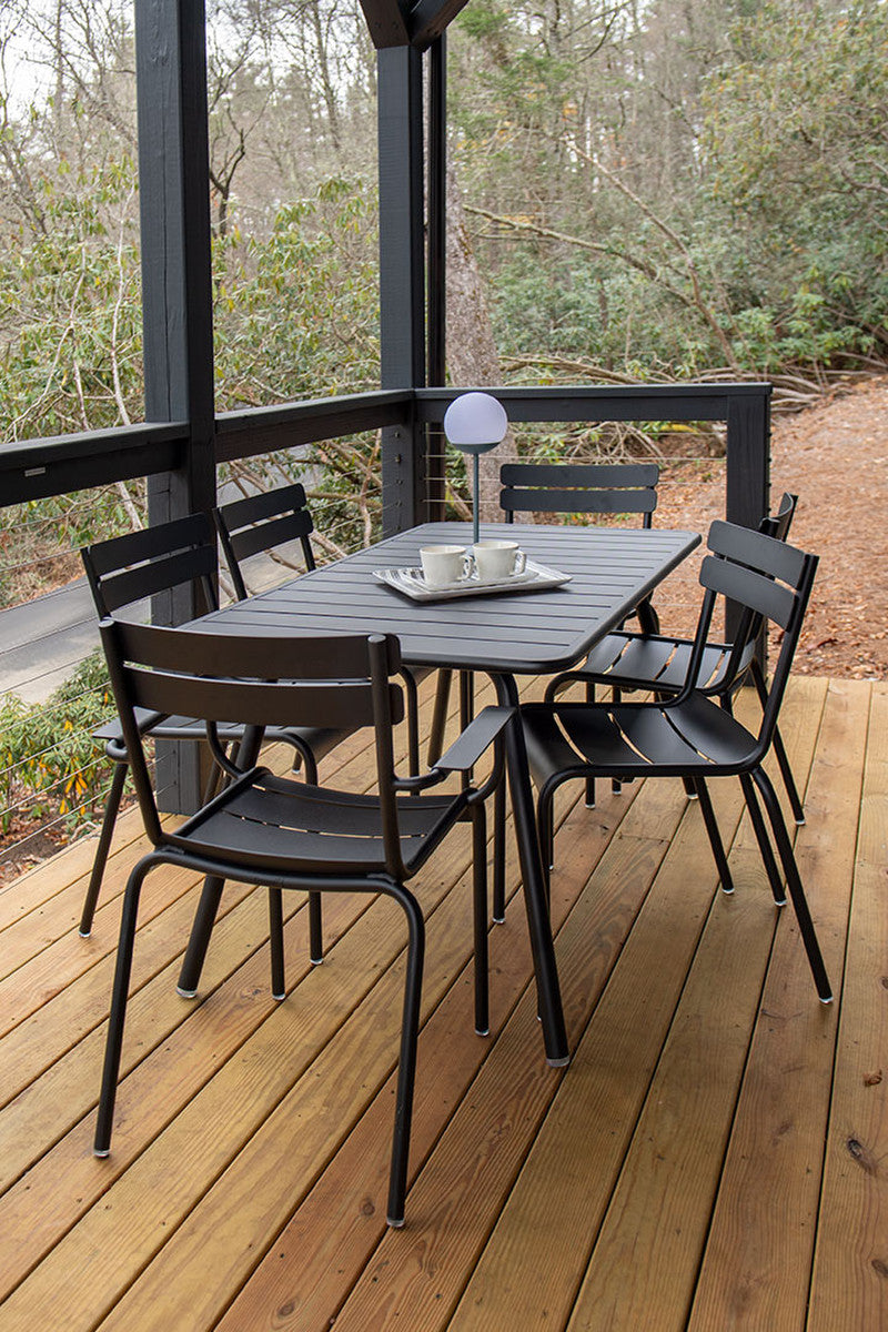 Six  black Luxembourg side chairs with tubular aluminum frame and curved aluminum slats.