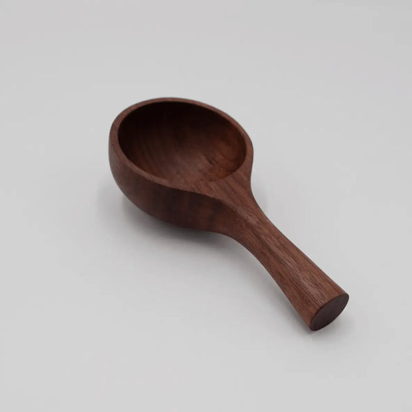 Wooden scoop on a light gray background