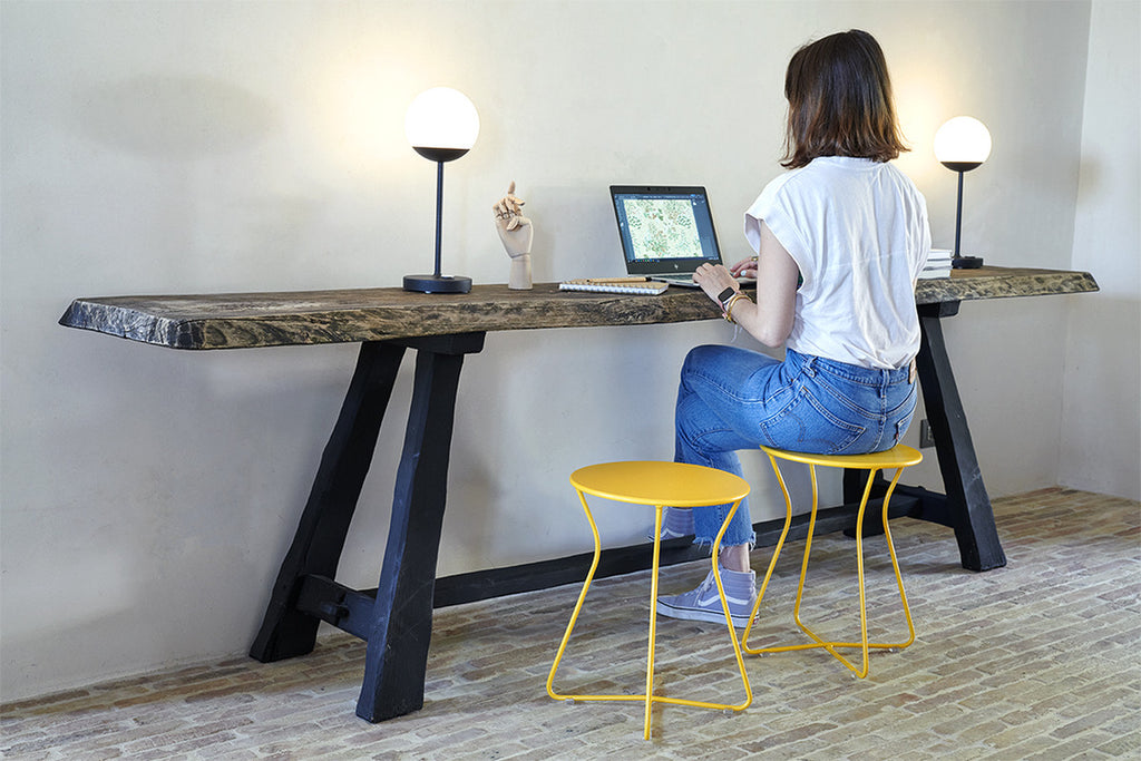 A modern, yellow Cocotte Stool with a steel rod frame.