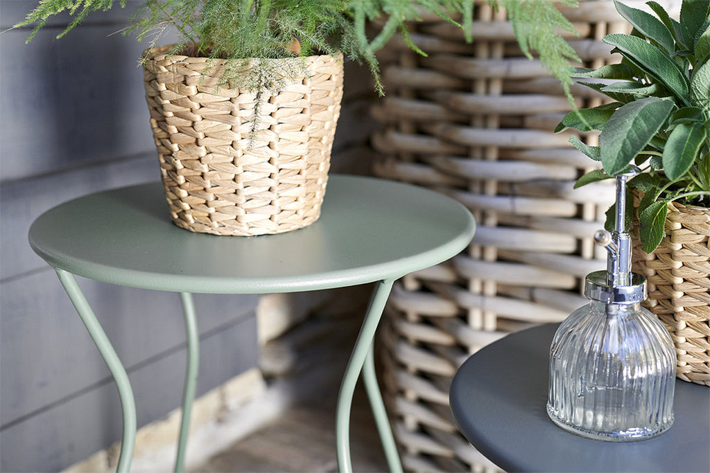 A modern, gray  and green Cocotte Stool with a steel rod frame.