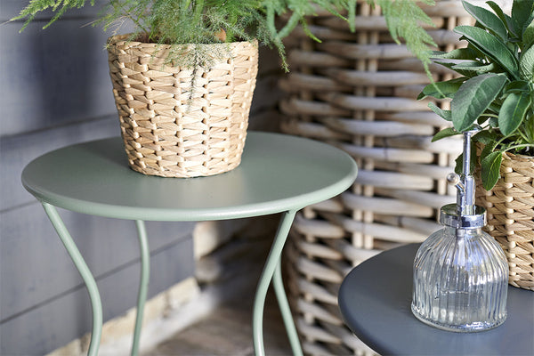 A modern, gray  and green Cocotte Stool with a steel rod frame.