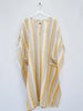 Striped kaftan with yellow and beige pattern on a white background