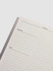 Planner with sections for priorities, schedule, and tasks on a white background