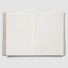 An open lined notebook or journal with blank white pages, shown against a light gray background.