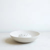 White ceramic bowl on a light gray background