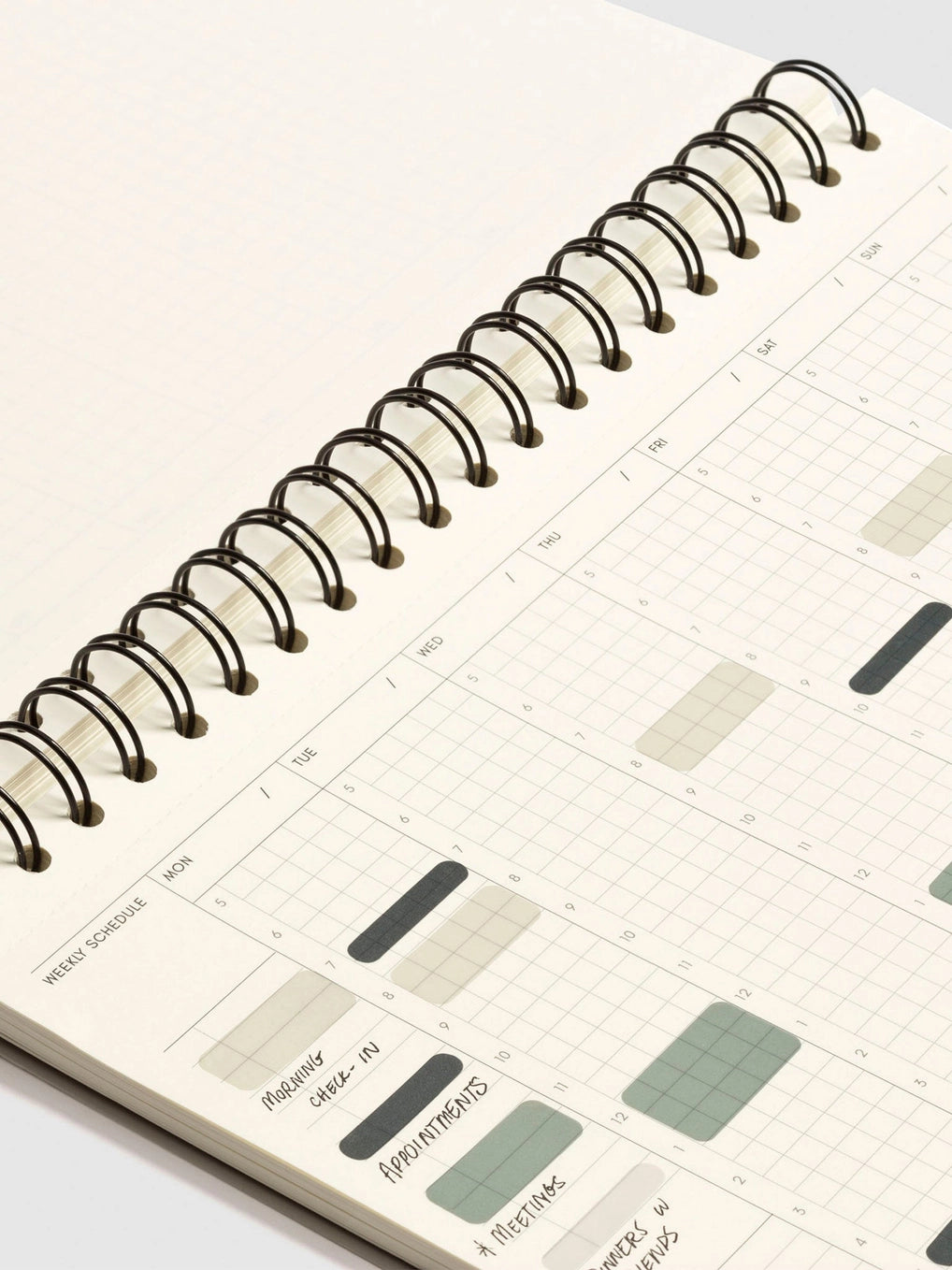 Spiral-bound planner with a minimalist design on a white background