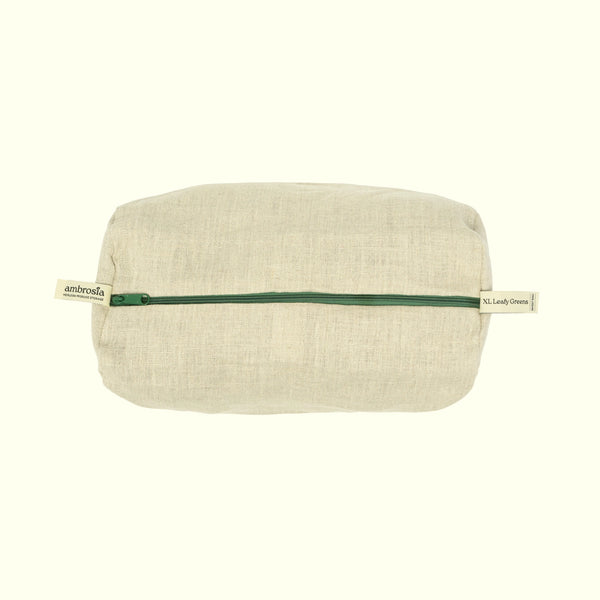 A rectangular beige linen pouch with a dark green zipper, featuring a small fabric brand tab on each end that reads 'ambrosia', set against a solid off-white background.