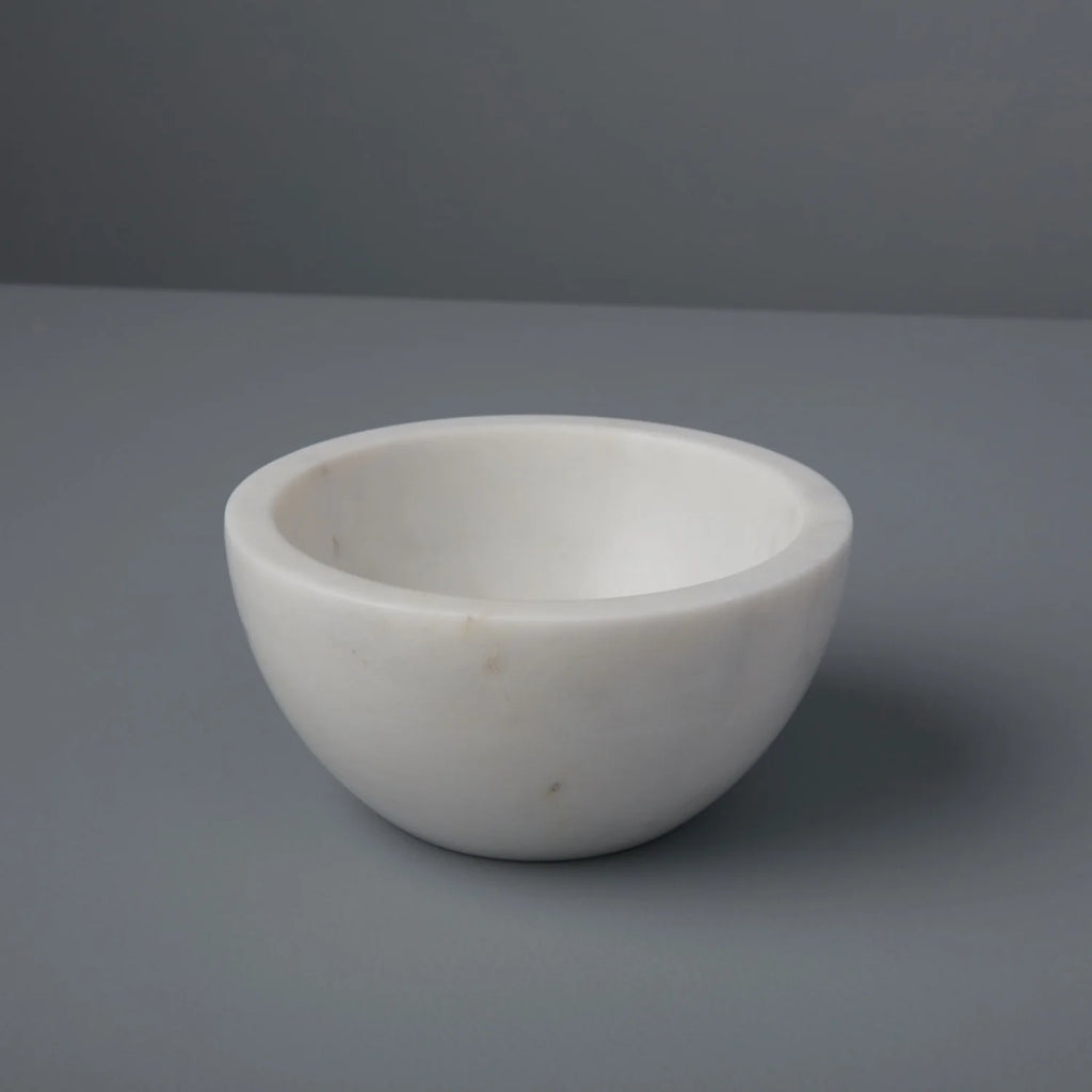 White marbke bowl on a grey background
