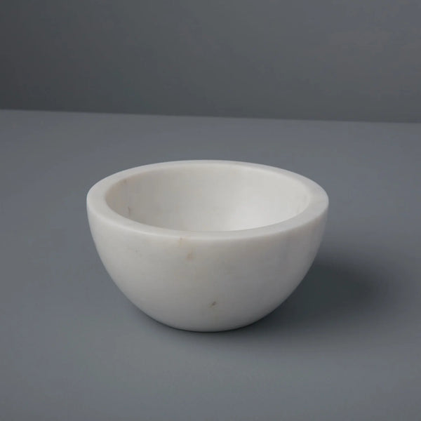 White marbke bowl on a grey background