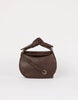 Brown leather handbag with a knot detail on a white background