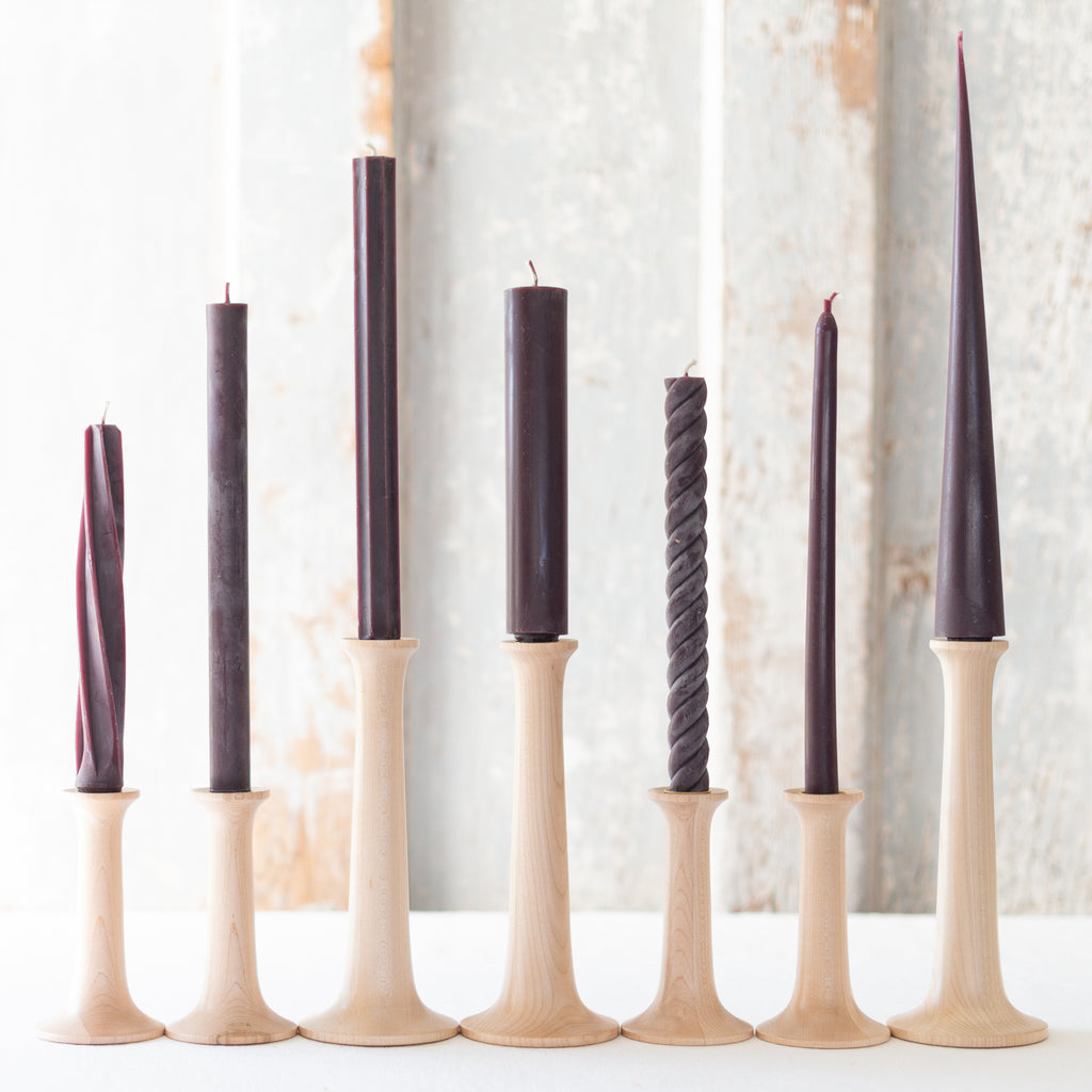 100% Beeswax Taper Candles on wooden candle stands.