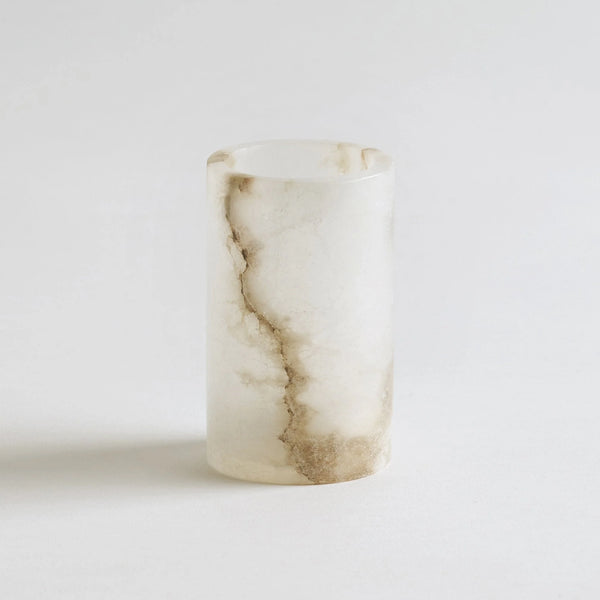 Marble-patterned candle holder on a light gray background