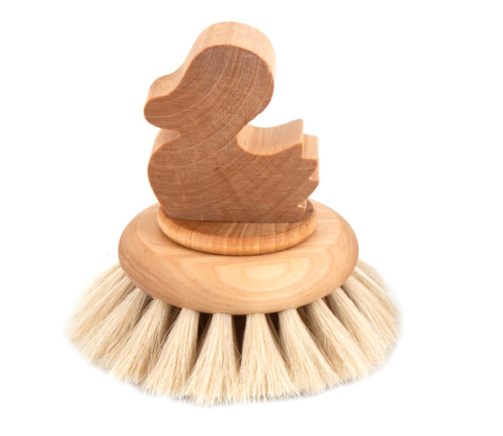 Wooden scrubber with a duck-shaped handle on a white background