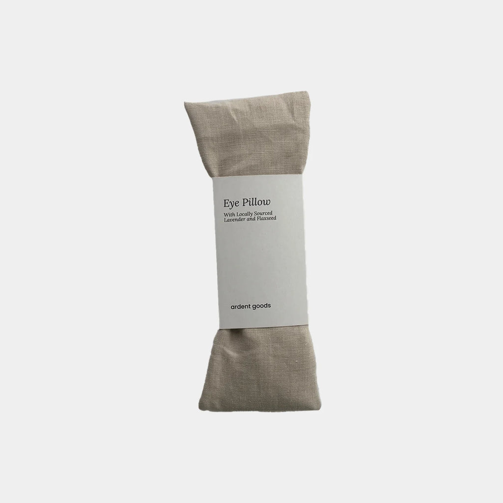 Fawn colored eye pillow with a label on a white background