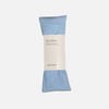 Sky blue eye pillow with a label on a white background