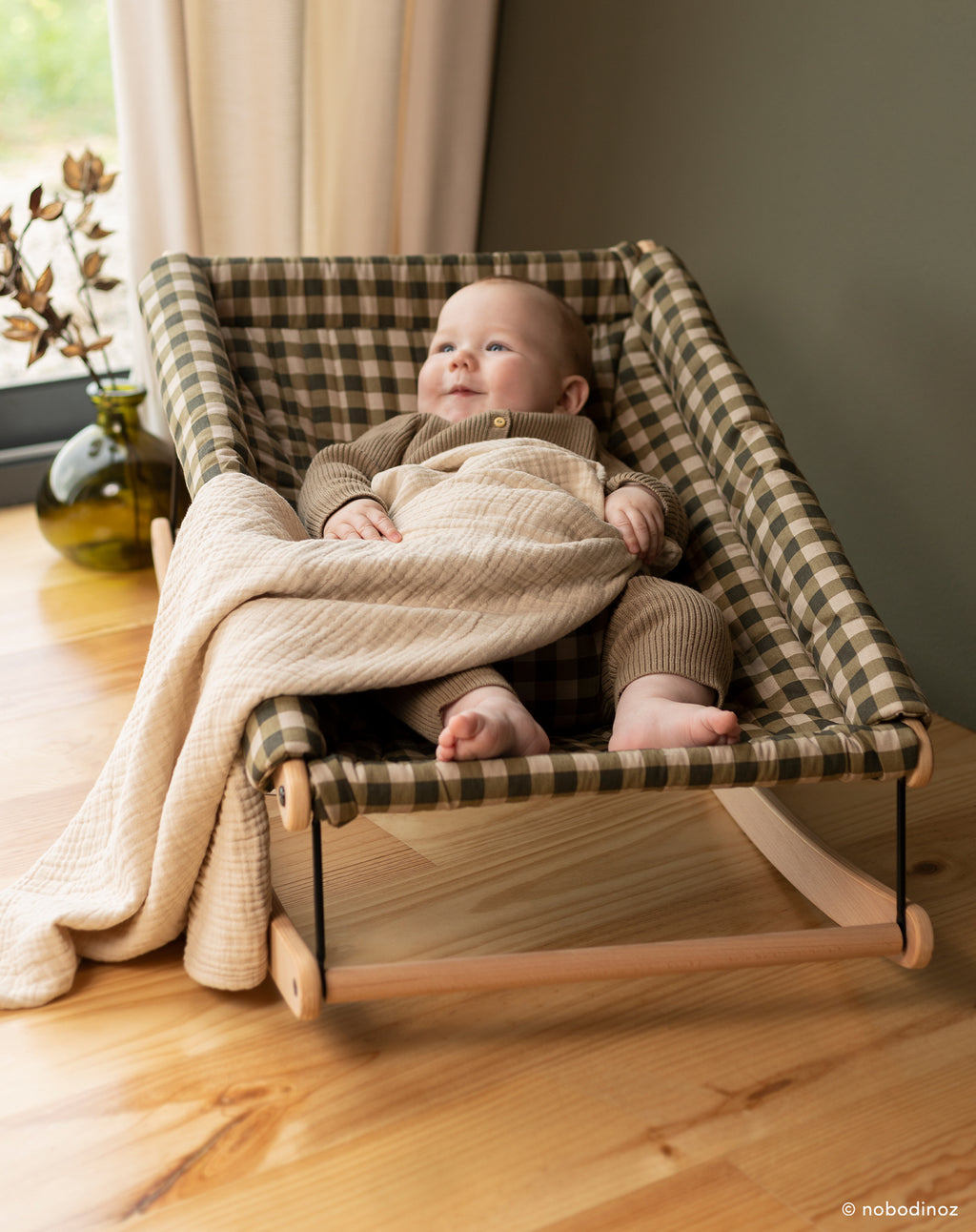 Happy baby in Growing Green Baby Bouncer with cover
