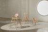 A closer shot of all three versions of the evolving wooden high chair