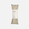 Oatmilk colored eye pillow with a label on a white background