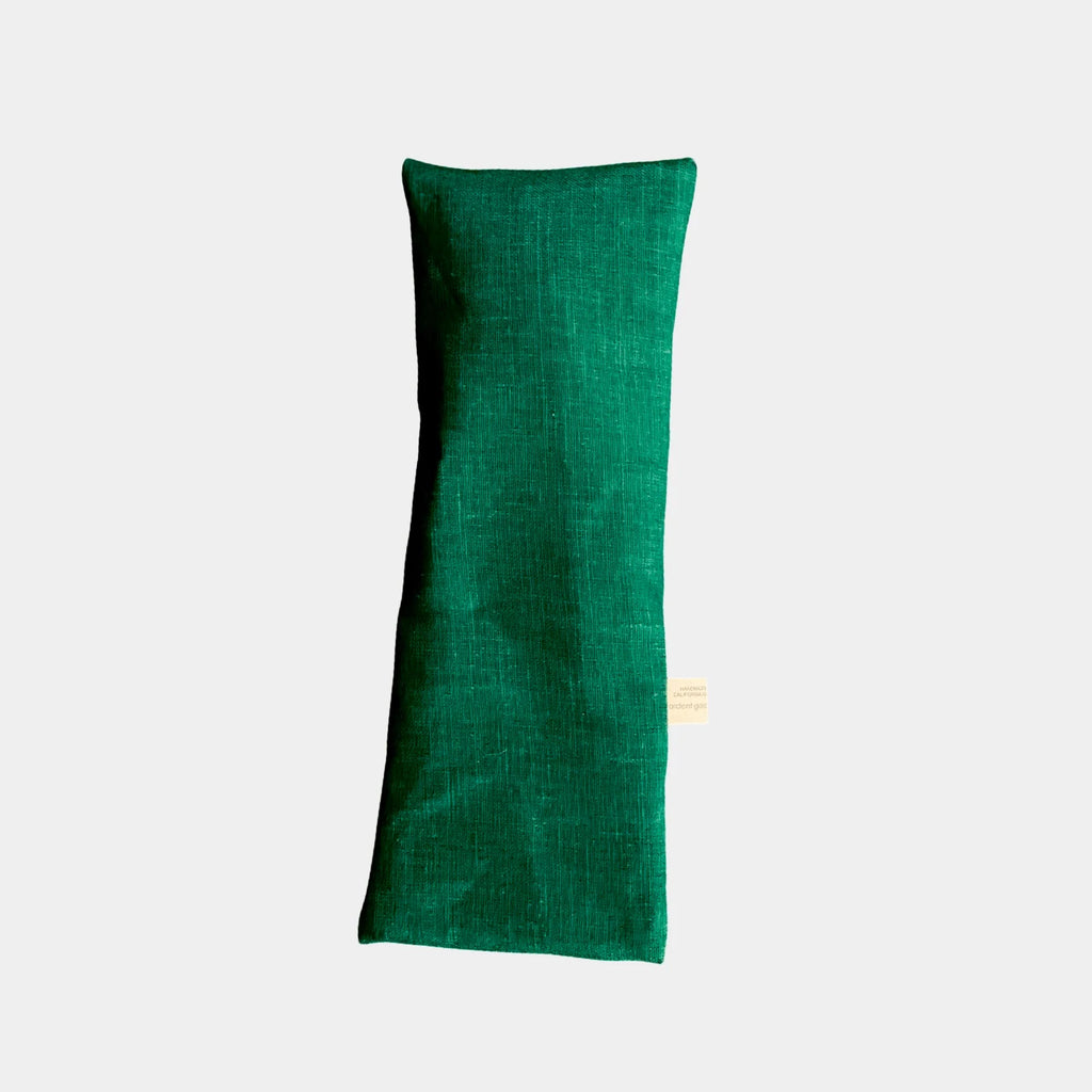 Forest green eye pillow on a white background