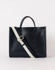 A black leather tote bag with a structured silhouette, featuring a white and red adjustable strap, two handles, and a minimalist latch closure.