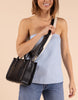 A model wearing the Jackie Midi in Black Leather