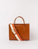A brown leather tote bag with a structured silhouette, featuring a white and red adjustable strap and two handles.