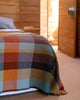 A made bed with a Vrou Mungo 100% cotton blanket