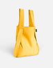 Yellow backpack on a light gray background