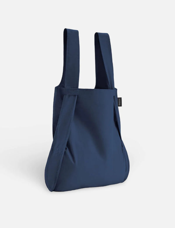 Navy blue backpack on a light gray background