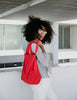Woman with a red bag in an urban setting
