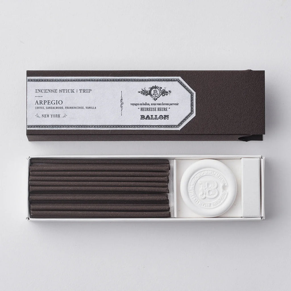 Incense sticks in a black box with a white label on a light gray background