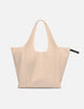 Beige tote bag with a visible brand label on a white background