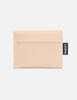 Beige pouch with a visible brand tag on a white background