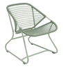 One cactus green low armchair with a criss-cross weave on an aluminum frame.
